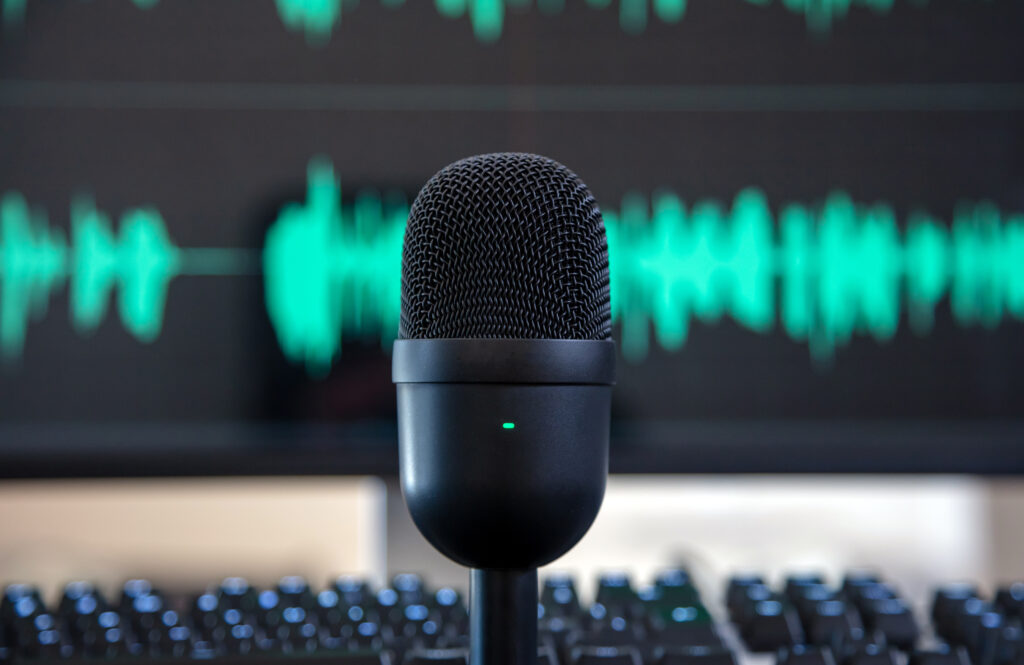 Condenser microphone with an audio waveform in the background
