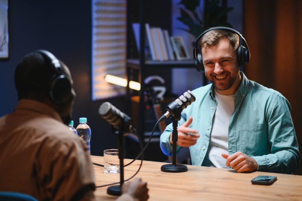 Podcast host interviewing a guest with professional microphones