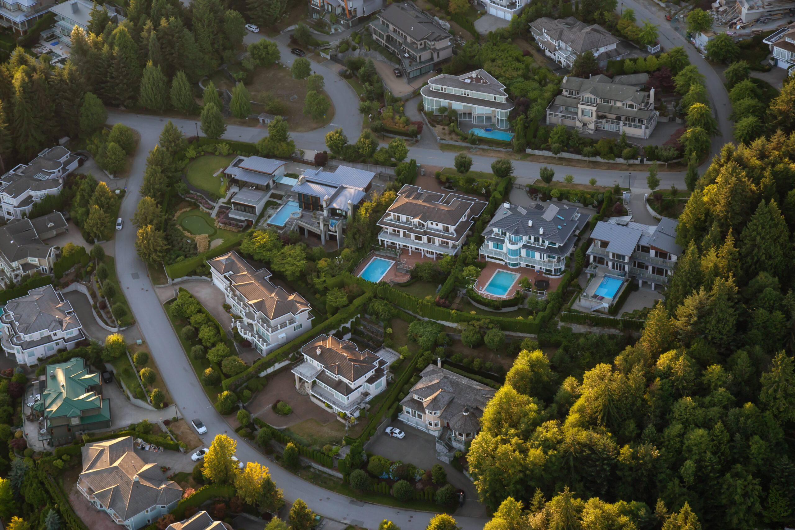 Aerial view of the big luxury homes on the hill during a vibrant sunny summer day. Taken in West Vancouver, British Columbia, Canada.